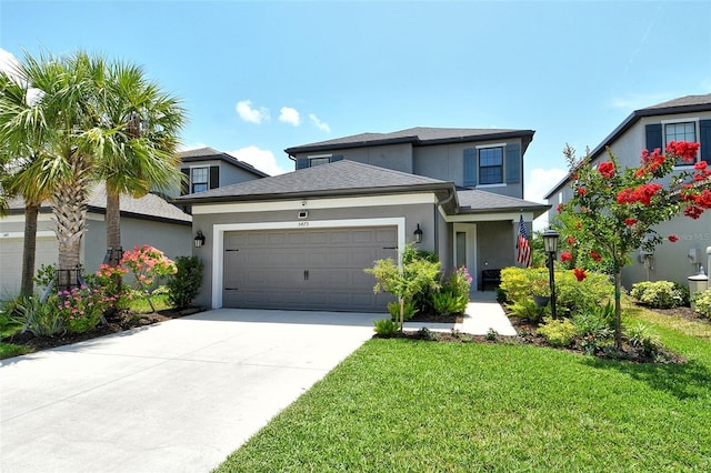 5475 Summit Gln, Bradenton, FL 34203 - view of front of property featuring a garage, stucco siding, a front lawn, and concrete driveway