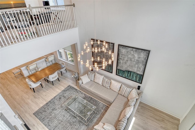 5475 Summit Gln, Bradenton, FL 34203 - living area featuring wood finished floors, a chandelier, baseboards, and a high ceiling