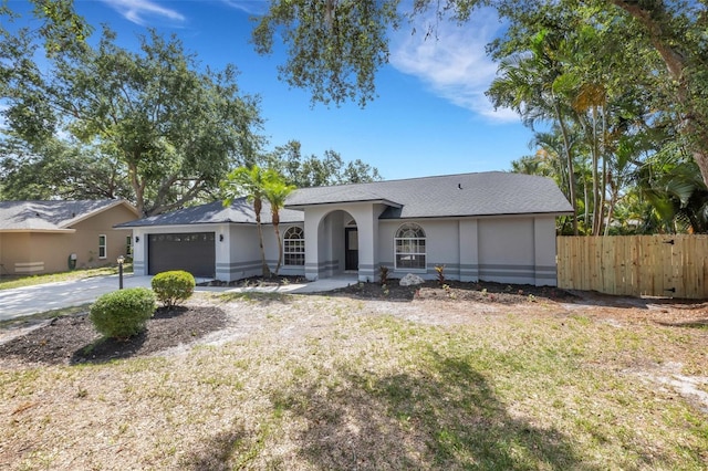 4473 Diamond Cir S, Sarasota, FL 34233 - ranch-style house featuring a garage, stucco siding, and driveway