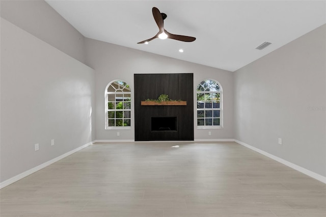4473 Diamond Cir S, Sarasota, FL 34233 - unfurnished living room with vaulted ceiling, light wood-style flooring, ceiling fan, a fireplace, and baseboards