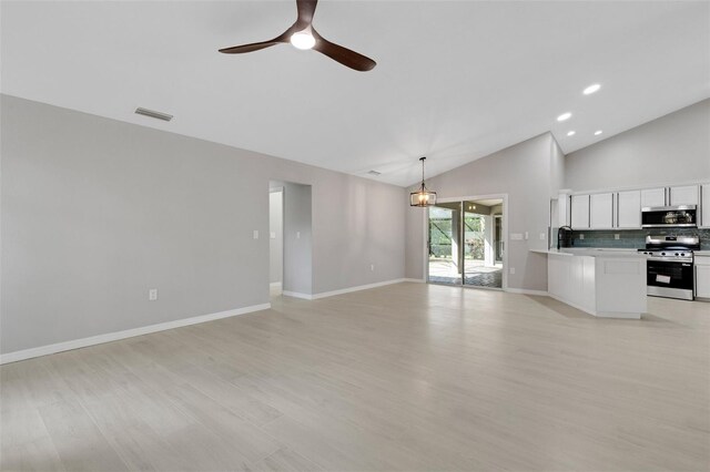 4473 Diamond Cir S, Sarasota, FL 34233 - unfurnished living room with a ceiling fan, light wood finished floors, baseboards, high vaulted ceiling, and recessed lighting