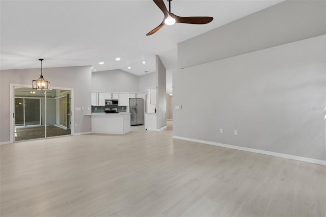 4473 Diamond Cir S, Sarasota, FL 34233 - unfurnished living room featuring baseboards, ceiling fan, light wood-style flooring, recessed lighting, and high vaulted ceiling
