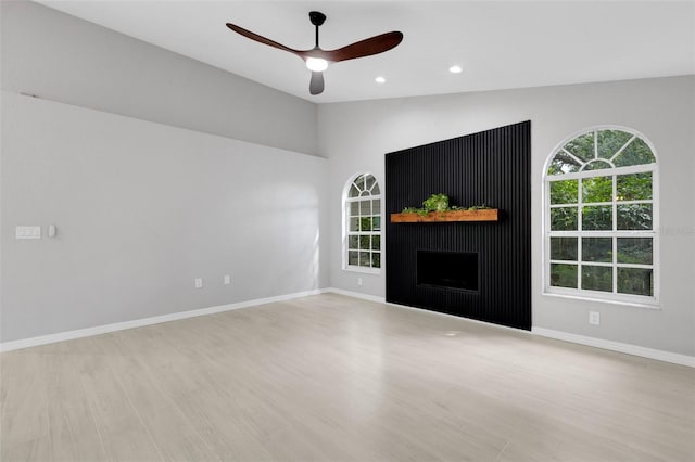 4473 Diamond Cir S, Sarasota, FL 34233 - unfurnished living room with a ceiling fan, wood finished floors, healthy amount of natural light, baseboards, and recessed lighting