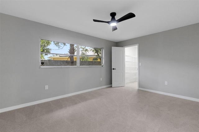 4473 Diamond Cir S, Sarasota, FL 34233 - unfurnished bedroom with carpet, baseboards, and ceiling fan