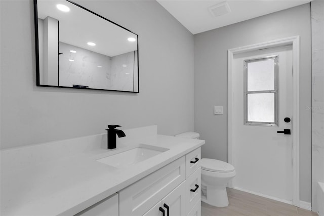 4473 Diamond Cir S, Sarasota, FL 34233 - full bath featuring vanity, toilet, a marble finish shower, wood finished floors, and recessed lighting