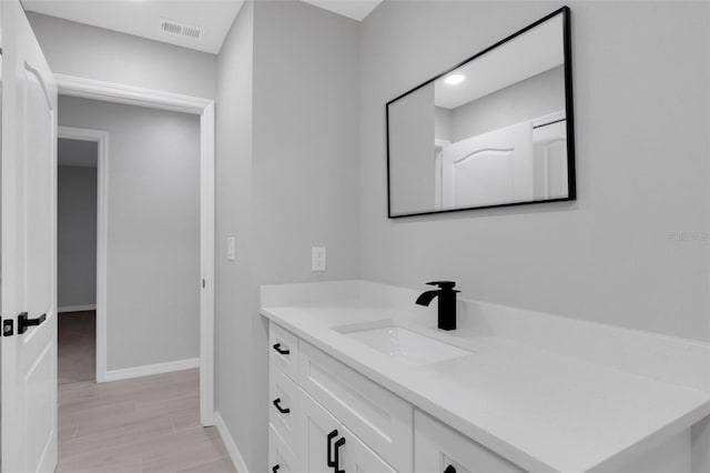 4473 Diamond Cir S, Sarasota, FL 34233 - bathroom featuring vanity, baseboards, and wood finished floors