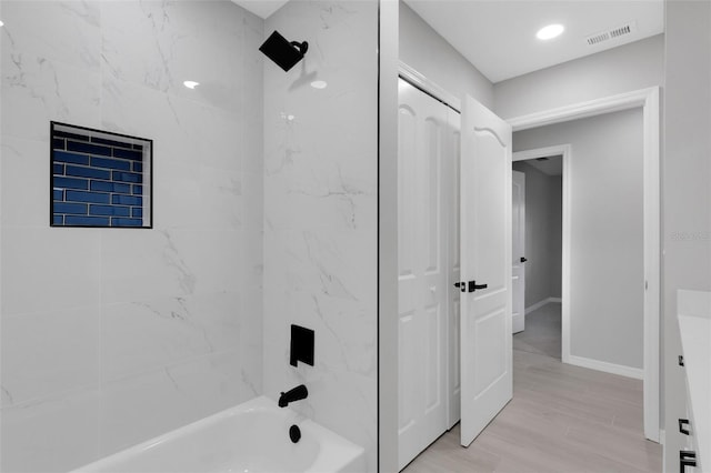 4473 Diamond Cir S, Sarasota, FL 34233 - bathroom with tub / shower combination, wood finished floors, vanity, and baseboards