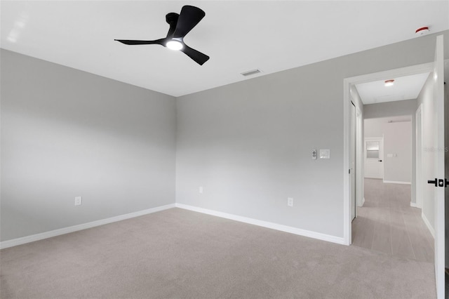 4473 Diamond Cir S, Sarasota, FL 34233 - empty room featuring light colored carpet, baseboards, a ceiling fan, and a smoke detector