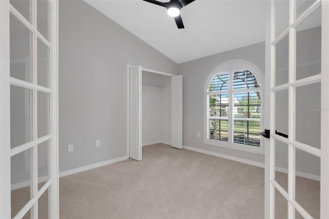 4473 Diamond Cir S, Sarasota, FL 34233 - unfurnished bedroom featuring french doors, carpet, lofted ceiling, baseboards, and a ceiling fan