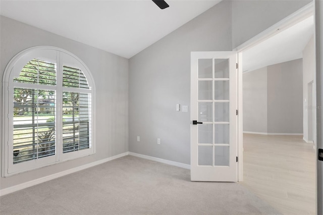 4473 Diamond Cir S, Sarasota, FL 34233 - empty room featuring baseboards, french doors, vaulted ceiling, ceiling fan, and carpet flooring