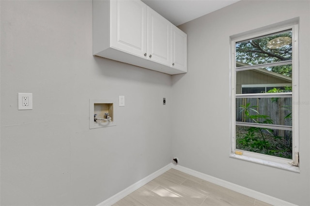4473 Diamond Cir S, Sarasota, FL 34233 - laundry area featuring electric dryer hookup, cabinet space, hookup for a washing machine, and baseboards