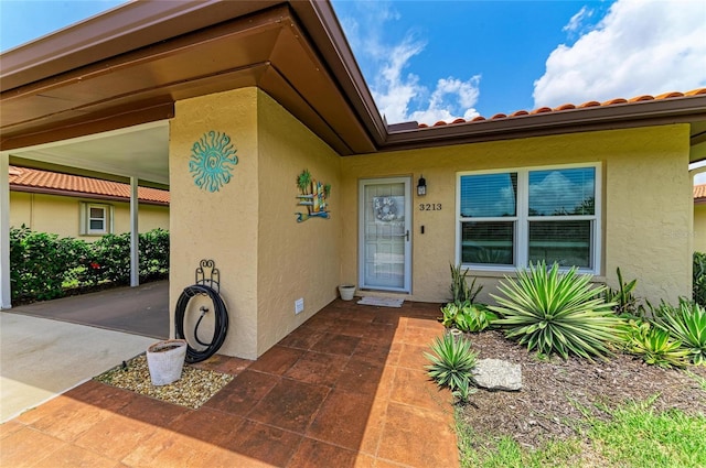 3213 Mercer Rd, Bradenton, FL 34207 - entrance to property with stucco siding and a tiled roof