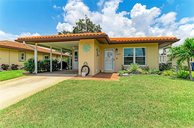 3213 Mercer Rd, Bradenton, FL 34207 - view of front of home featuring stucco siding, a front lawn, and concrete driveway