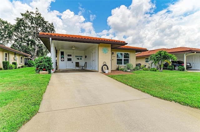 3213 Mercer Rd, Bradenton, FL 34207 - mediterranean / spanish house with driveway, a tiled roof, and a front yard