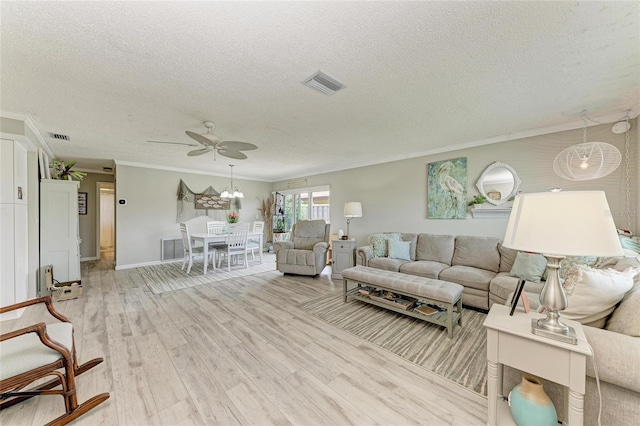 3213 Mercer Rd, Bradenton, FL 34207 - living room with a textured ceiling, ornamental molding, a ceiling fan, light wood-style floors, and baseboards