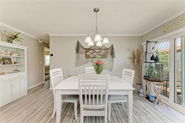 3213 Mercer Rd, Bradenton, FL 34207 - dining room featuring a chandelier, a textured ceiling, ornamental molding, and light wood-style flooring