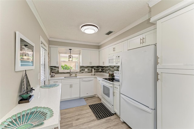 3213 Mercer Rd, Bradenton, FL 34207 - kitchen featuring white appliances, a sink, crown molding, a textured ceiling, and light countertops