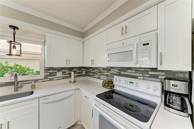 3213 Mercer Rd, Bradenton, FL 34207 - kitchen featuring white appliances, a sink, decorative backsplash, white cabinetry, and light countertops
