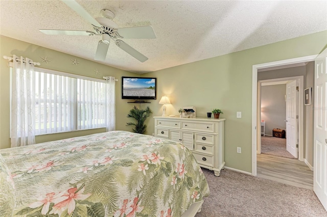 3213 Mercer Rd, Bradenton, FL 34207 - bedroom featuring a textured ceiling, light colored carpet, ceiling fan, and baseboards