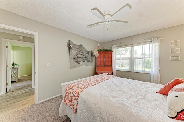 3213 Mercer Rd, Bradenton, FL 34207 - bedroom with baseboards, carpet, ceiling fan, wood finished floors, and a textured ceiling