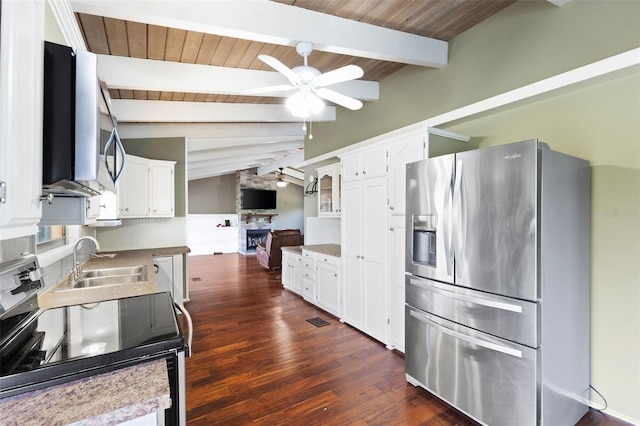 6406 Lincoln Rd, Bradenton, FL 34203 - kitchen with stainless steel fridge, range with electric cooktop, ceiling fan, dark wood-type flooring, and white cabinets
