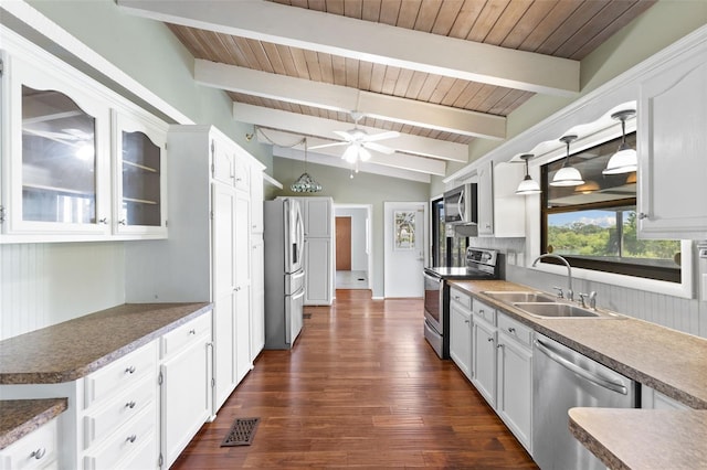 6406 Lincoln Rd, Bradenton, FL 34203 - kitchen with appliances with stainless steel finishes, white cabinetry, ceiling fan, dark wood finished floors, and wooden ceiling