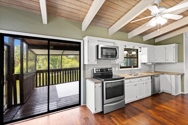 6406 Lincoln Rd, Bradenton, FL 34203 - kitchen featuring appliances with stainless steel finishes, a ceiling fan, white cabinetry, a wood ceiling with exposed beams, and light countertops