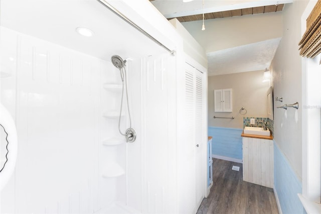 6406 Lincoln Rd, Bradenton, FL 34203 - full bath featuring wood finished floors, vanity, recessed lighting, wainscoting, and a shower