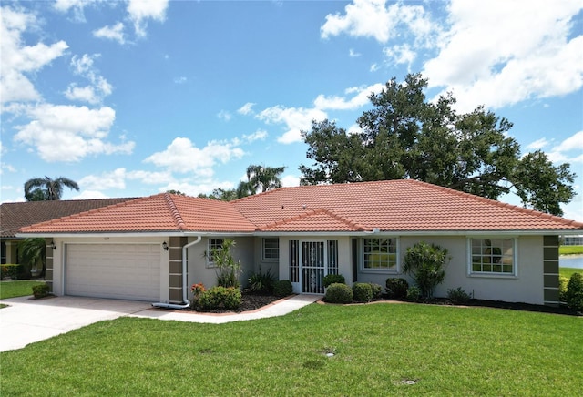 1654 Waxwing Ct, Venice, FL 34293 - single story home with stucco siding, a tile roof, a front yard, and an attached garage