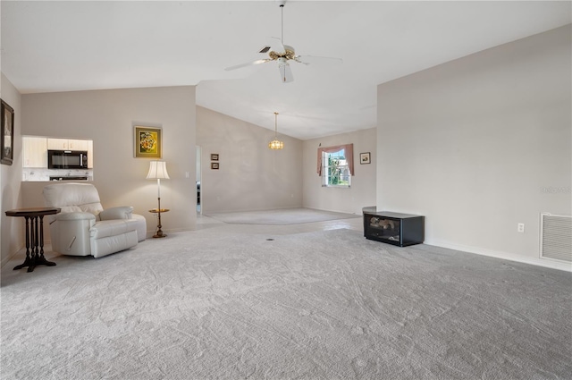 1654 Waxwing Ct, Venice, FL 34293 - living room with lofted ceiling, carpet flooring, a ceiling fan, and baseboards