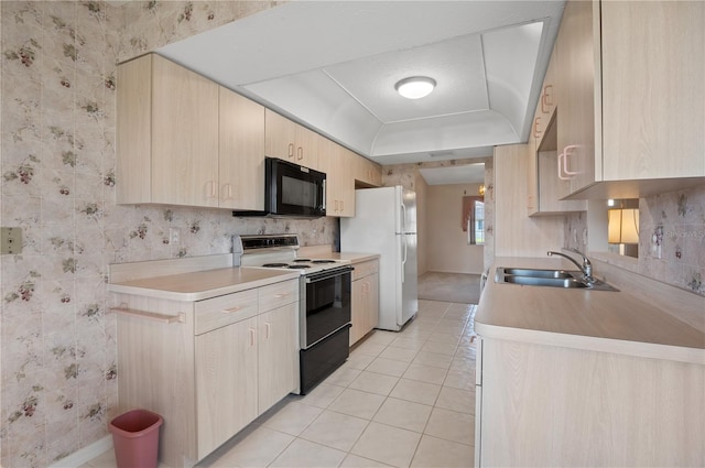 1654 Waxwing Ct, Venice, FL 34293 - kitchen featuring electric range, black microwave, light brown cabinetry, wallpapered walls, and freestanding refrigerator