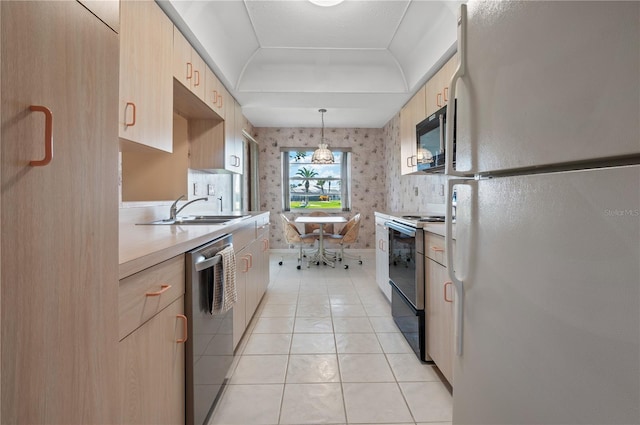 1654 Waxwing Ct, Venice, FL 34293 - kitchen with freestanding refrigerator, electric stove, stainless steel dishwasher, black microwave, and light brown cabinets
