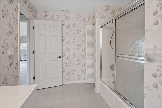 1654 Waxwing Ct, Venice, FL 34293 - bathroom featuring wallpapered walls, enclosed tub / shower combo, tile patterned flooring, and baseboards