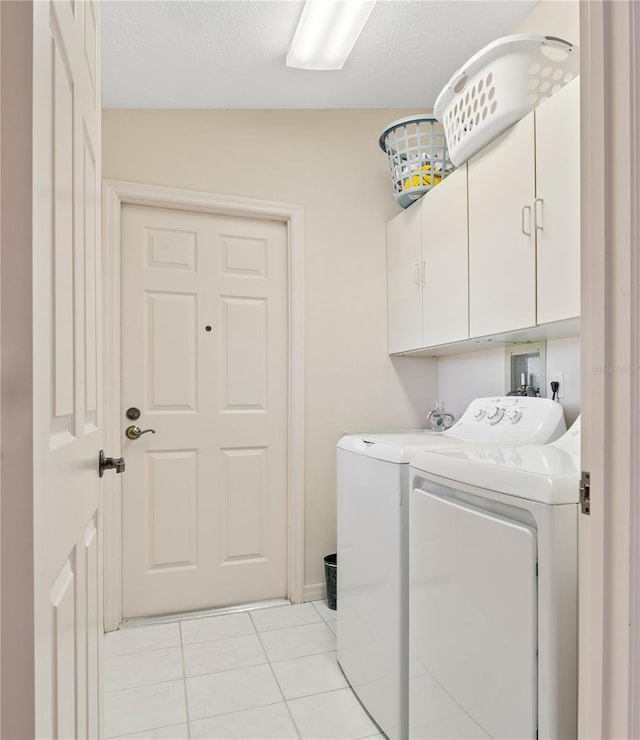 1654 Waxwing Ct, Venice, FL 34293 - washroom featuring washing machine and clothes dryer, cabinet space, and light tile patterned floors