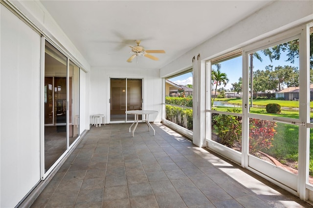1654 Waxwing Ct, Venice, FL 34293 - unfurnished sunroom with a ceiling fan, a water view, and radiator