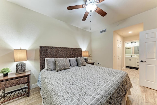 7911 Grand Estuary Trl Unit 102, Bradenton, FL 34212 - bedroom with light wood finished floors, ensuite bathroom, and baseboards