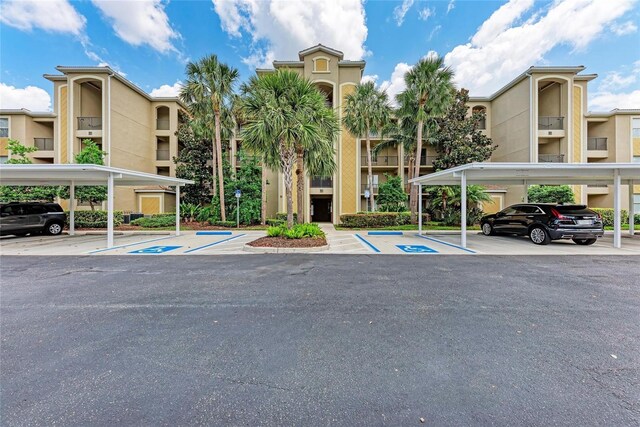 7911 Grand Estuary Trl Unit 102, Bradenton, FL 34212 - view of building exterior featuring covered and uncovered parking