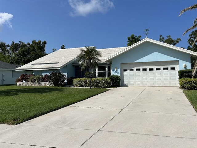 1279 Vermeer Dr, Nokomis, FL 34275 - ranch-style house with a garage, driveway, a front lawn, stucco siding, and a tile roof