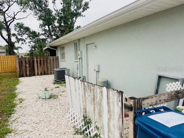 8409 43rd Ave W, Bradenton, FL 34209 - view of home's exterior with stucco siding and central AC