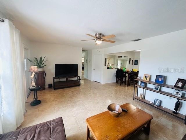 8409 43rd Ave W, Bradenton, FL 34209 - living room featuring ceiling fan and light tile patterned floors