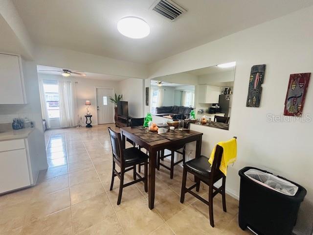 8409 43rd Ave W, Bradenton, FL 34209 - dining area featuring light tile patterned floors and ceiling fan
