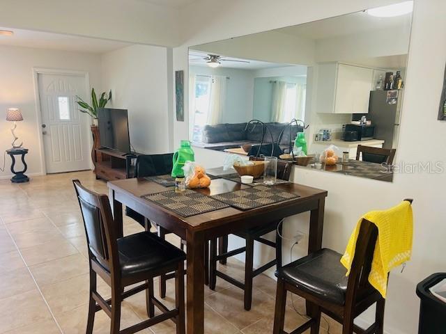 8409 43rd Ave W, Bradenton, FL 34209 - dining space featuring healthy amount of natural light, a ceiling fan, and light tile patterned flooring
