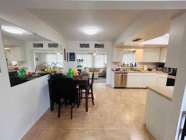 8409 43rd Ave W, Bradenton, FL 34209 - kitchen featuring dishwasher, white cabinetry, light tile patterned floors, light countertops, and a sink