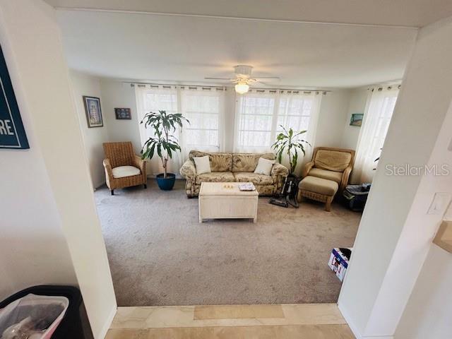 8409 43rd Ave W, Bradenton, FL 34209 - living area featuring light colored carpet and ceiling fan