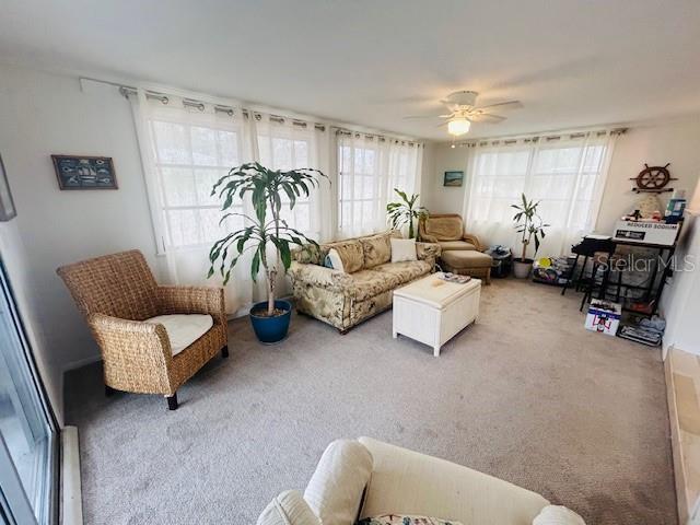 8409 43rd Ave W, Bradenton, FL 34209 - carpeted living room with a ceiling fan