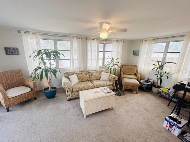 8409 43rd Ave W, Bradenton, FL 34209 - living room featuring light colored carpet and ceiling fan
