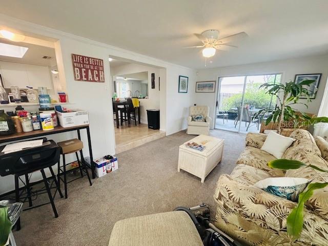 8409 43rd Ave W, Bradenton, FL 34209 - carpeted living room with ceiling fan and a skylight