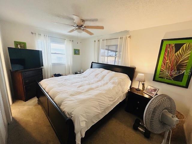 8409 43rd Ave W, Bradenton, FL 34209 - bedroom featuring light colored carpet and a ceiling fan