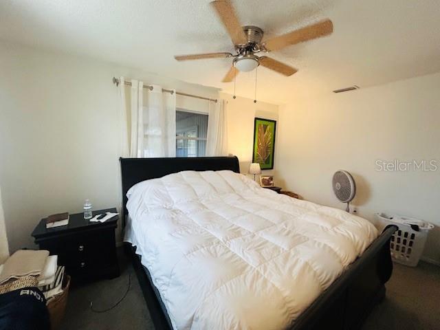 8409 43rd Ave W, Bradenton, FL 34209 - carpeted bedroom featuring ceiling fan