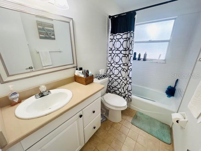 8409 43rd Ave W, Bradenton, FL 34209 - full bath with vanity, tile patterned flooring, shower / tub combo with curtain, and toilet